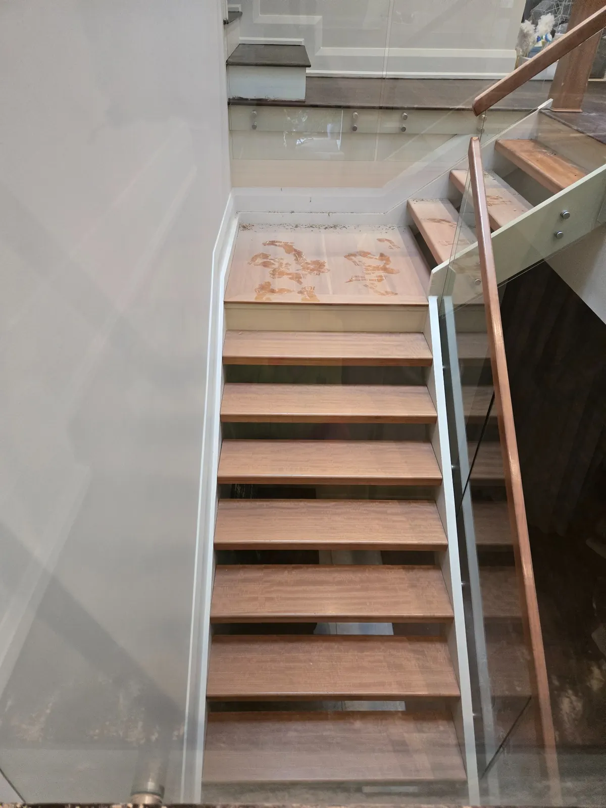 Stairs overview showing construction dust covering steps, risers, and surrounding surfaces