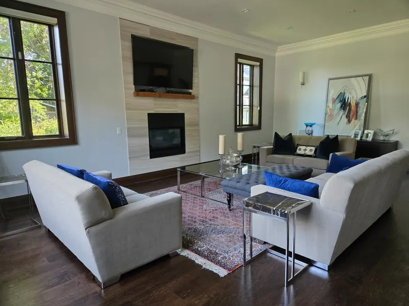 Living room fully cleaned and reset after renovation — furniture, rugs, and decor restored to original placement using client reference photos
